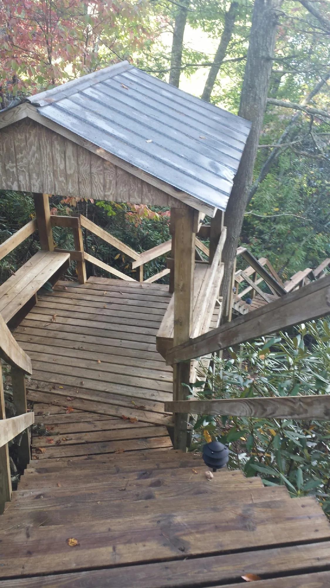 Metal roofed shelter over wooden steps on a wooded walkway — Skylight Repair & Installation work by our crew in Mahwah