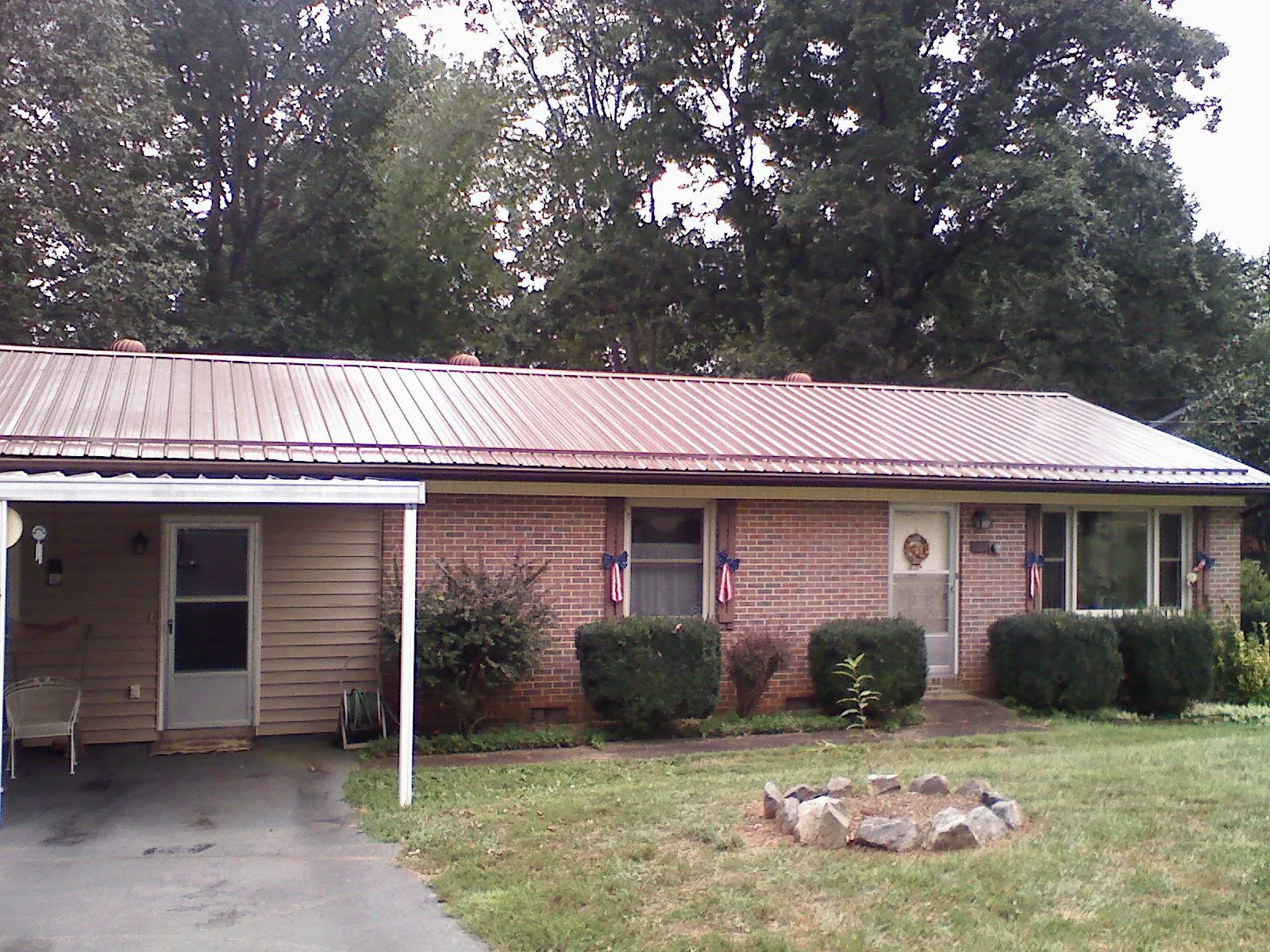 Bronze metal roof and carport on a brick ranch home — Roof Repair work by our crew in Mahwah