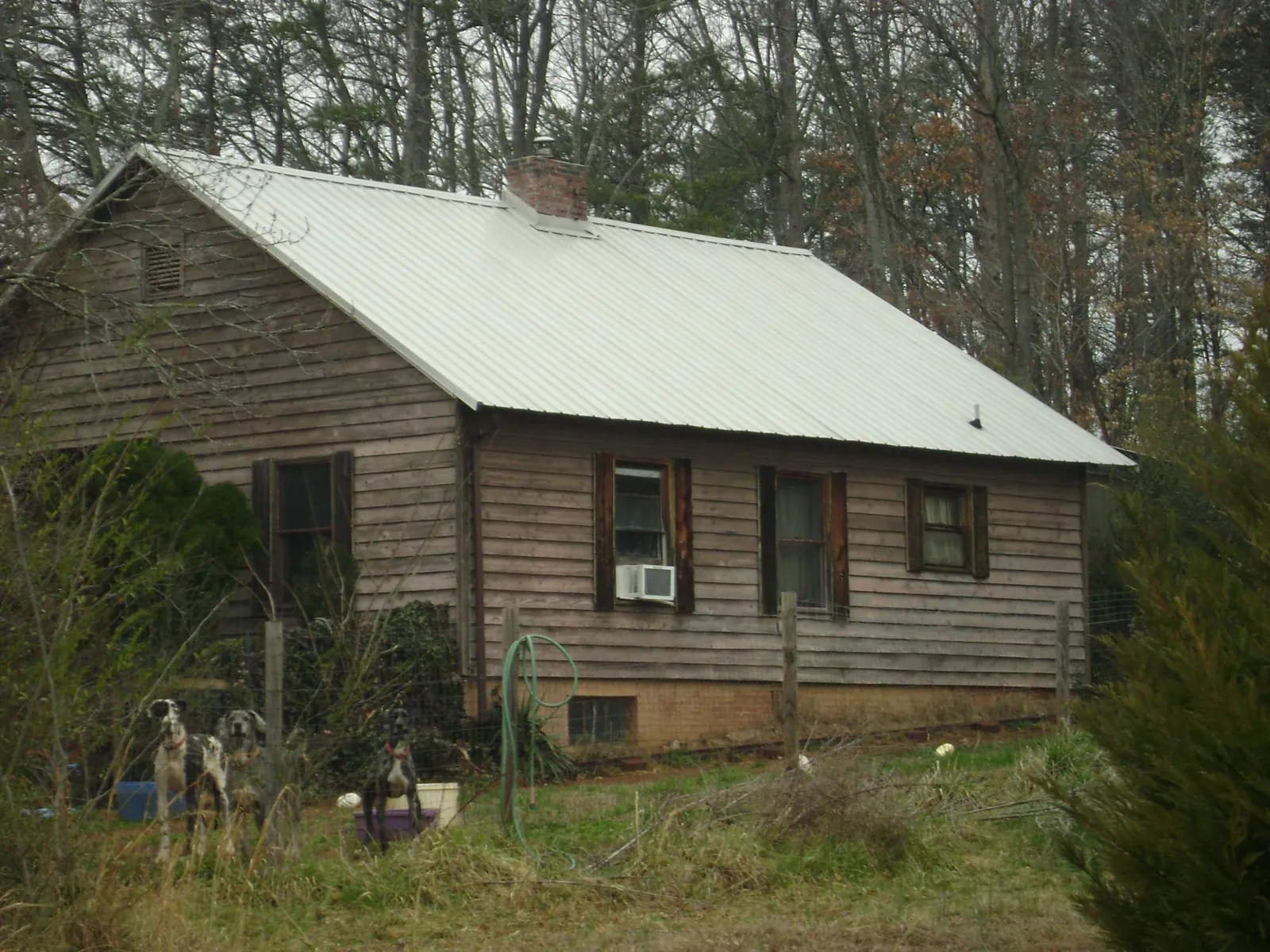 White metal roof on an old wood sided farmhouse, from a Metal Roof Installation job in Mahwah